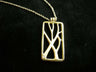 Vineyard 14K gold rectangular pendant with branching vine cutouts and a small diamond on black