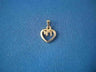 Petite 14K yellow gold open heart pendant with a Chai inside, on blue fabric
