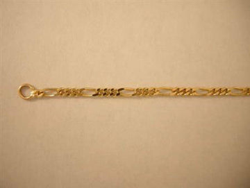 Close view of a gold Figaro chain with three short links between each long link