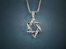 Antiqued silver interwoven Star of David pendant with twisted texture on a box chain, blue backdrop