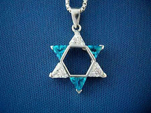 Sterling Star of David pendant with alternating turquoise and clear triangle stones on blue fabric