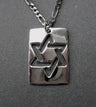 Rectangular polished sterling tag with a cut-out interlaced Star of David on a figaro chain