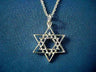 Layered silver Star of David with an inner star inside an interwoven outer star, on blue