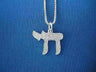 Sterling silver Chai with fine wood grain lines on a box chain, laid on blue