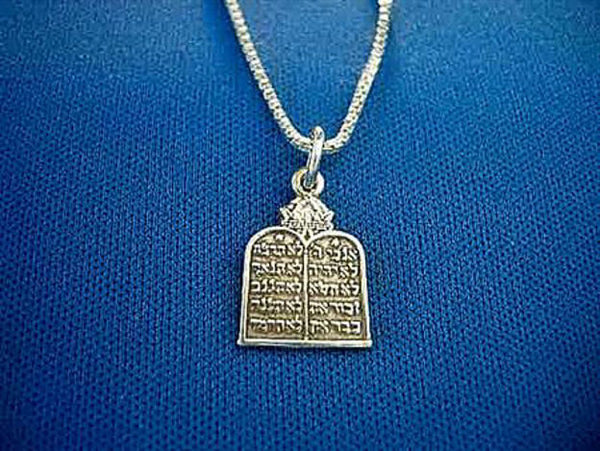Sterling silver twin tablets pendant with engraved Hebrew text on a box chain, blue fabric