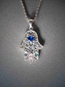 Sterling filigree hamsa pendant with a blue heart stone and pink and light blue stones on a rope chain