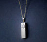 Polished silver mezuzah charm topped with a Star of David enclosing Hebrew letters, on dark blue