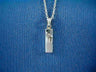 Small polished silver mezuzah charm with a raised Chai, on a cable chain over blue fabric