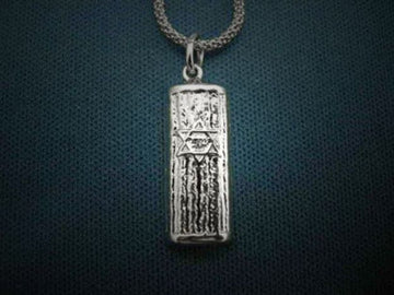 Oxidized, ridged silver mezuzah pendant with a Star of David at center on a textured chain