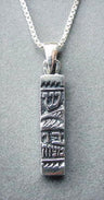 Oxidized silver mezuzah charm with raised Hebrew letters including Shin, on a box chain