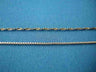 Two chains on blue fabric; the lower one is the antique-finish sterling box chain