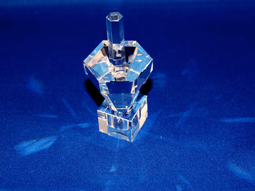 Hexagon crystal dreidel with tall stem viewed from above on a deep blue background