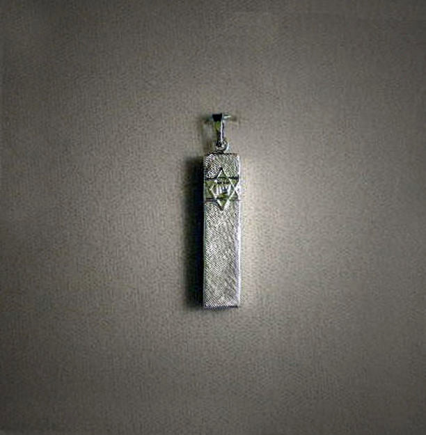 Florentine-textured silver mezuzah charm shown alone without chain on a grey backdrop