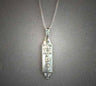 Silver mezuzah pendant with a Star of David and raised Hebrew letters, on a chain