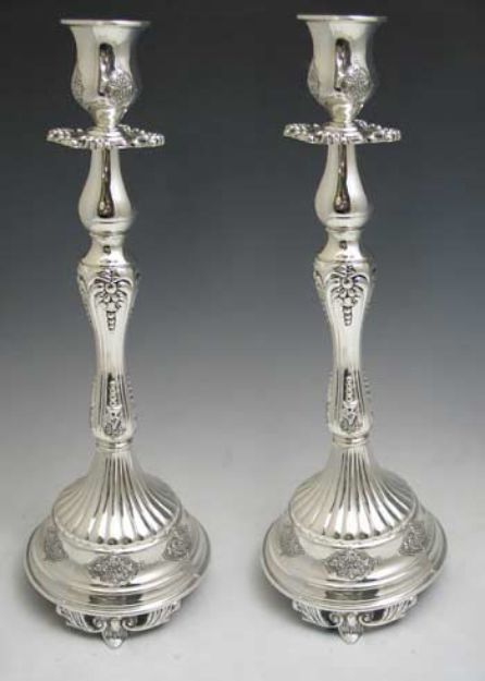 Pair of tall silver plated candlesticks with fluted footed bases and ornate baluster stems