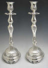 Pair of tall silver plated candlesticks with fluted footed bases and ornate baluster stems