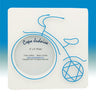 White square frame with blue wire tricycle, round photo window and Star of David front wheel