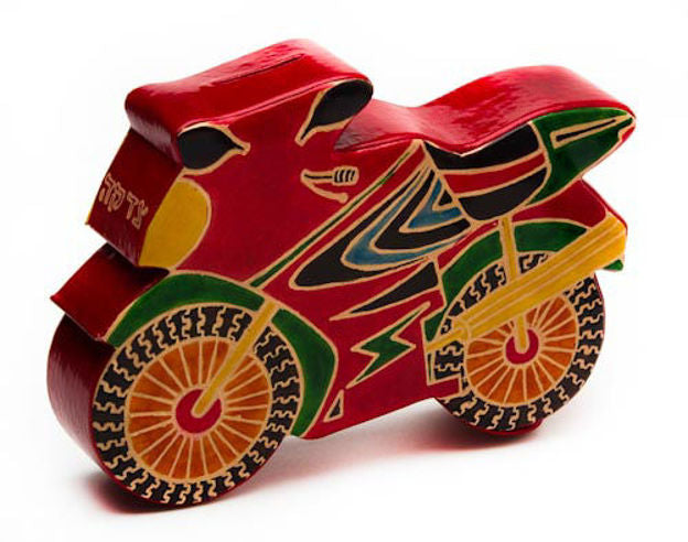Red tooled leather motorbike tzedakah box with green and yellow details and spoked wheels