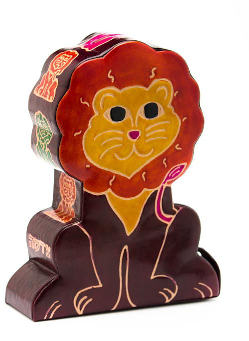 Hand-painted tooled leather lion tzedakah box standing upright, red mane and smiling gold face