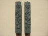 Black lava composite stone fig mezuzah case shown beside a second case, fruit relief and shin