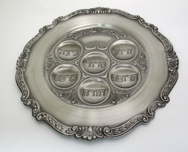 Pewter Passover plate angled view showing Hebrew-marked wells in a circle and ornate edge