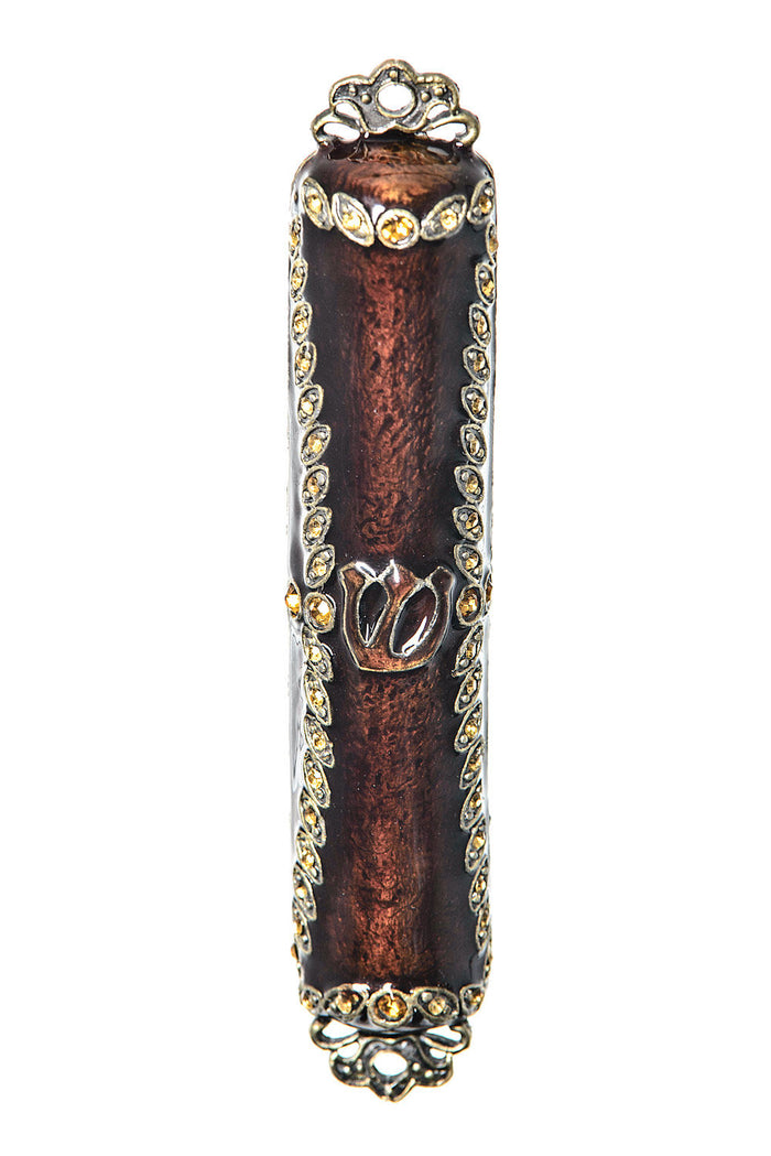 Brown enamel mezuzah case bordered in amber and clear stones with a Shin at center and scalloped gold-tone ends