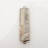 Mother of pearl mezuzah case with silver edging, a silver Shin and loops at each end