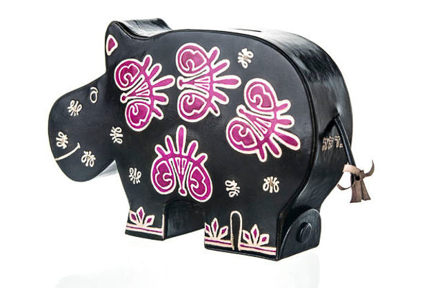 Black hippo tzedakah box hand-painted with purple and white floral shapes