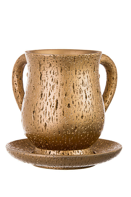 Two-handled gold-tone wash cup with drip texture standing on a matching round tray