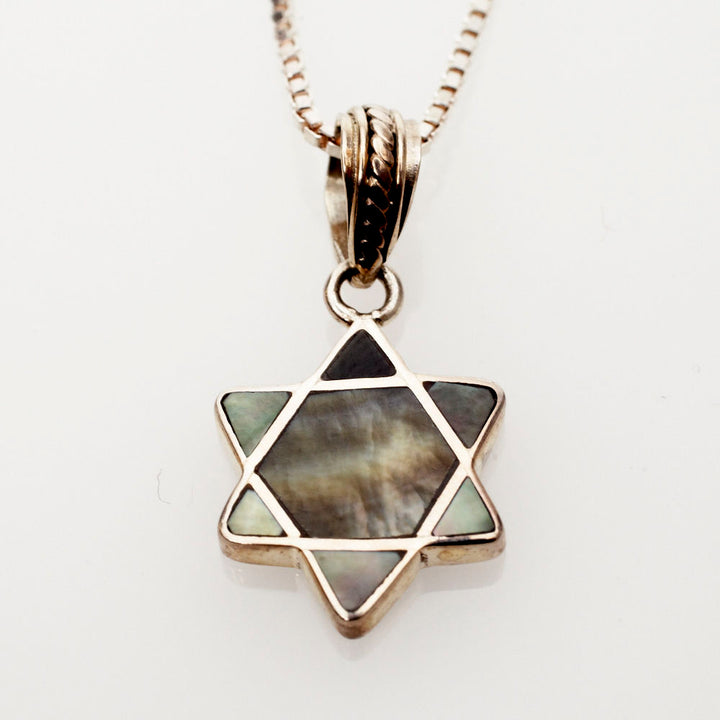 Mini Star of David pendant inlaid with grey and black mussel shell on a sterling box chain