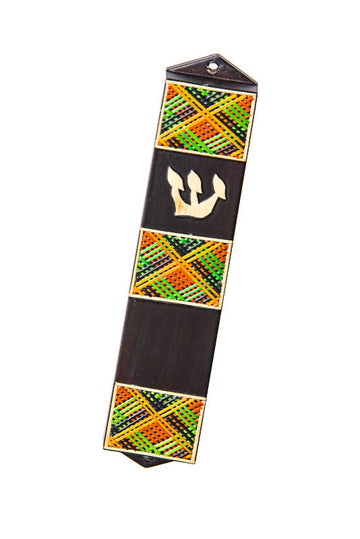 Dark wood mezuzah case with three green, orange and black straw panels and a straw Shin