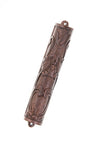 Dark ebony mezuzah case with flowing carved floral relief and end loops, angled view