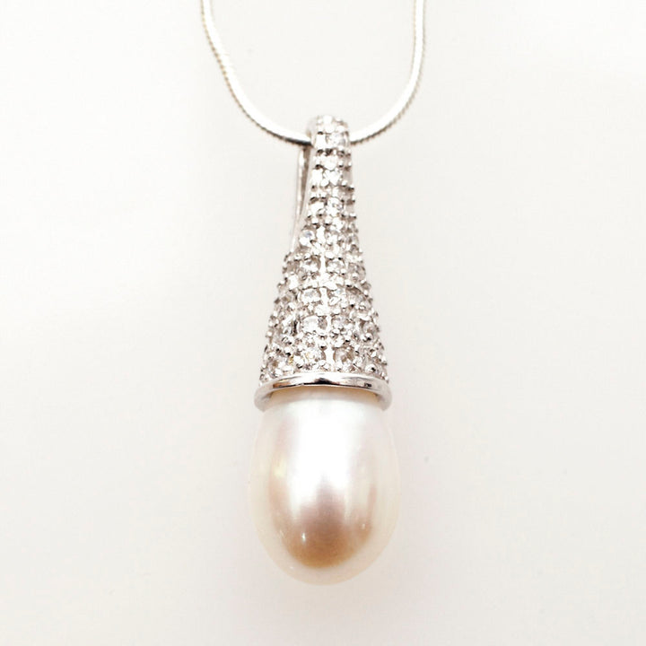 Teardrop white pearl under a pave CZ cone cap, sterling silver drop pendant on snake chain