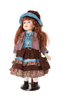 Sharon porcelain doll with long auburn hair, blue hat and tiered brown floral skirt on a display stand