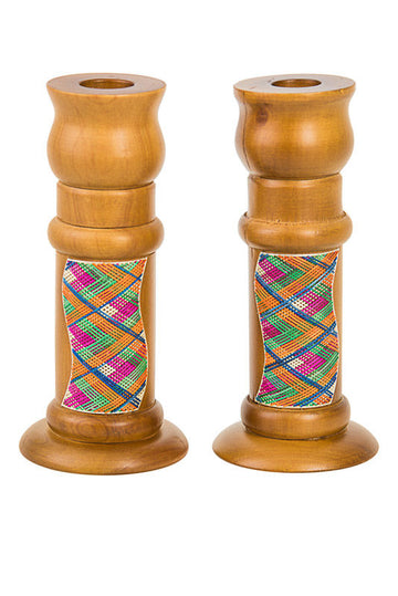 Pair of light wood candlesticks with pink, green and blue woven straw panels on the stems