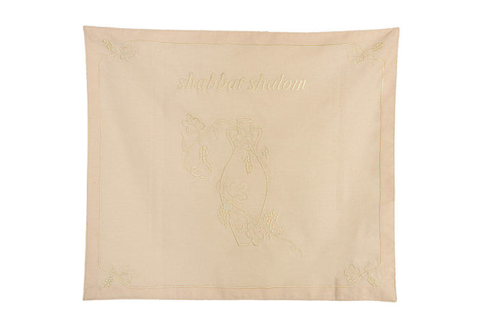 Bisque cotton challah cover embroidered with Shabbat Shalom and a water jar with flowering branches
