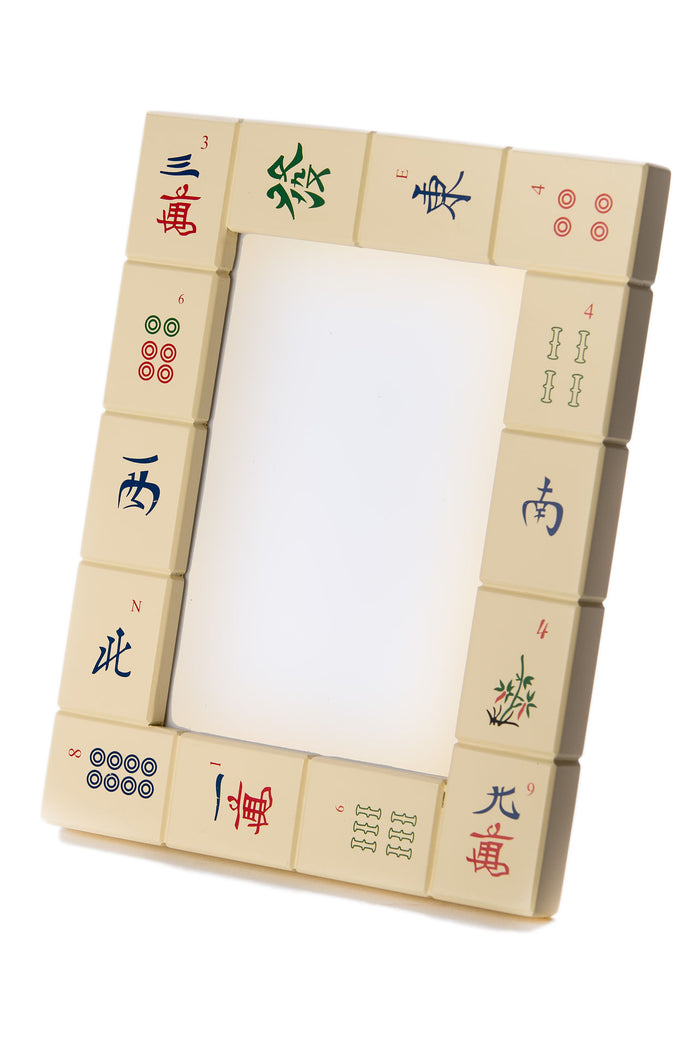 Picture frame made of ivory painted Mah Jongg tiles with red, green and blue symbols, standing upright