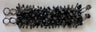Dark wide beaded bracelet with black stone chips and gunmetal fringe, laid flat on white