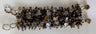 Wide bracelet mixing brown tiger's eye, black onyx and clear quartz chips with gold-tone loops