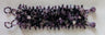 Purple and black gemstone bracelet laid flat, showing amethyst chips and beaded end loops