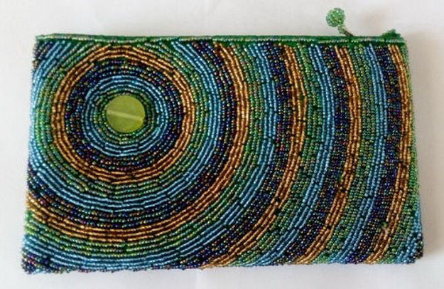 Beaded purse with concentric blue, gold and green rings around a green button accent