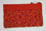 Orange-red beaded clutch with a mixed red, pink and orange bead body and a ring at the top edge