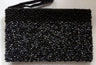 Black hematite beaded purse with a beaded wrist strap at the top left corner