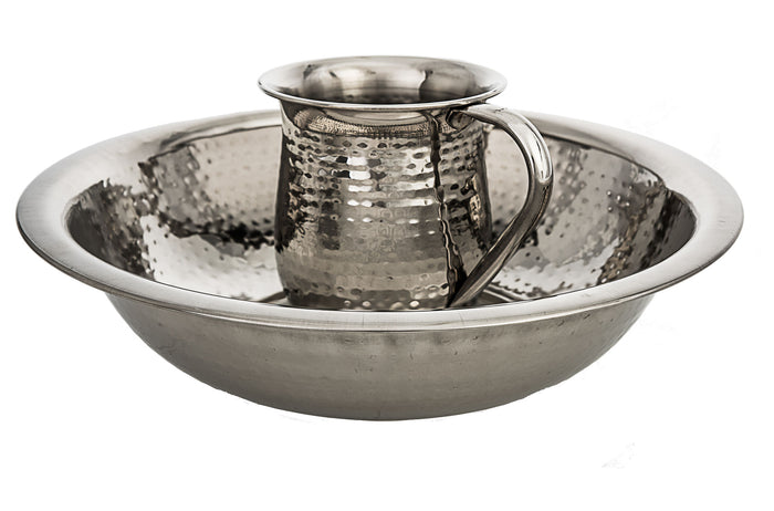 Hammered nickel wash cup with banded rings resting in a wide hammered basin