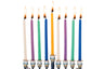 Nine lit smooth Chanukah candles in white, purple, green, blue and yellow in a menorah