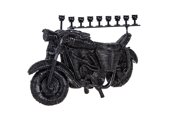 Black coiled-texture motorcycle menorah with nine candle cups on a rail above the seat