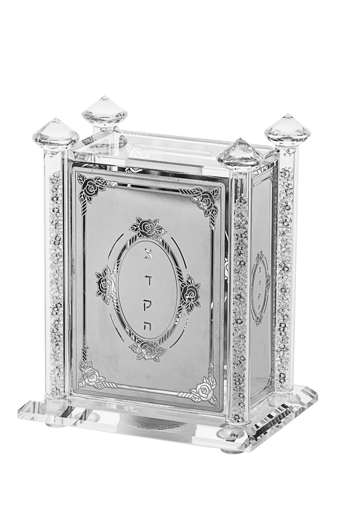 Crystal tzedakah box with silver-tone flower panel, Hebrew lettering and faceted corner finials