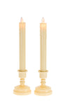 Two ivory LED taper candles with glowing flame tips standing in matching candleholder bases