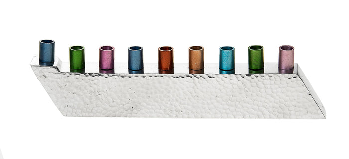 Low hammered stainless steel menorah with a slanted base and nine multicolored candle cups