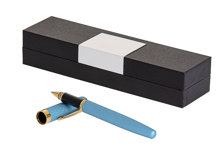 Light blue pen with gold-tone clip and trim lying in front of a black presentation box